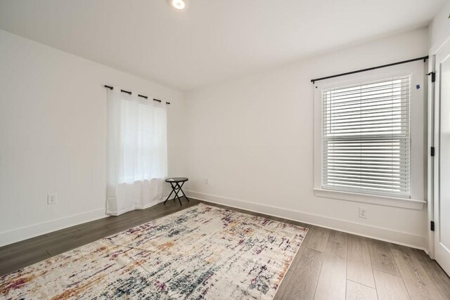 bedroom with wood finished floors, baseboards, and ceiling fan