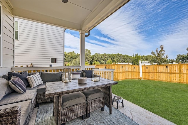 view of patio featuring an outdoor living space and fence