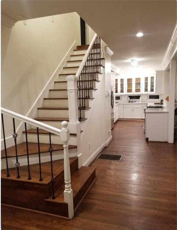 stairway featuring dark wood-type flooring