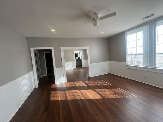 unfurnished room featuring dark hardwood / wood-style floors and ceiling fan