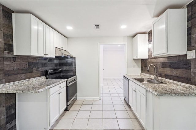 kitchen with stainless steel dishwasher, a sink, decorative backsplash, range with electric cooktop, and under cabinet range hood