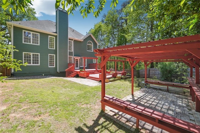 view of yard featuring a pergola, a patio area, a fenced backyard, and a deck