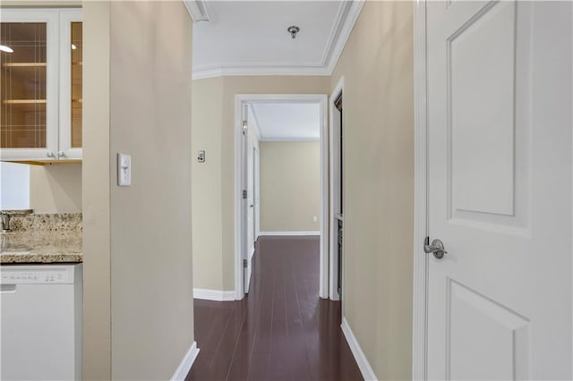 hallway with ornamental molding and dark wood-type flooring