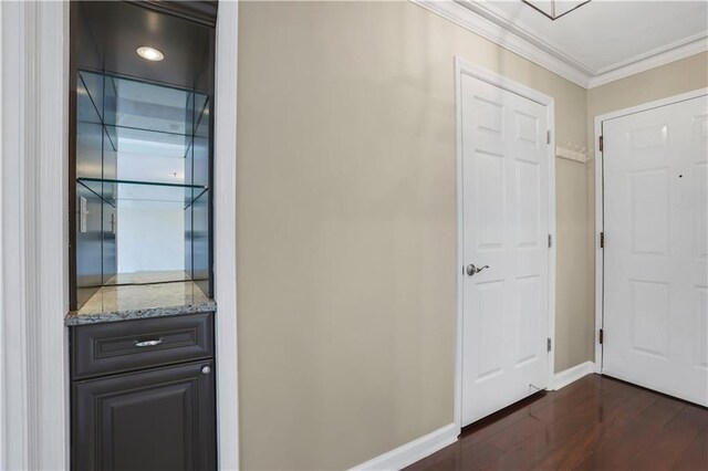 hall with ornamental molding and dark hardwood / wood-style flooring