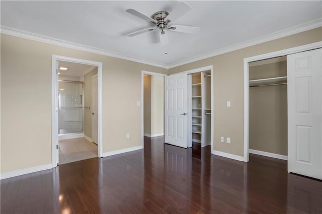 unfurnished bedroom with ensuite bath, crown molding, ceiling fan, tile patterned floors, and two closets