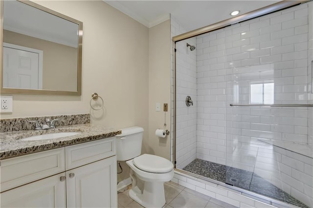 bathroom featuring a shower with shower door, vanity, toilet, and tile patterned flooring