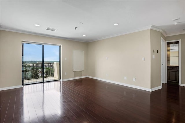 empty room featuring dark hardwood / wood-style flooring and ornamental molding