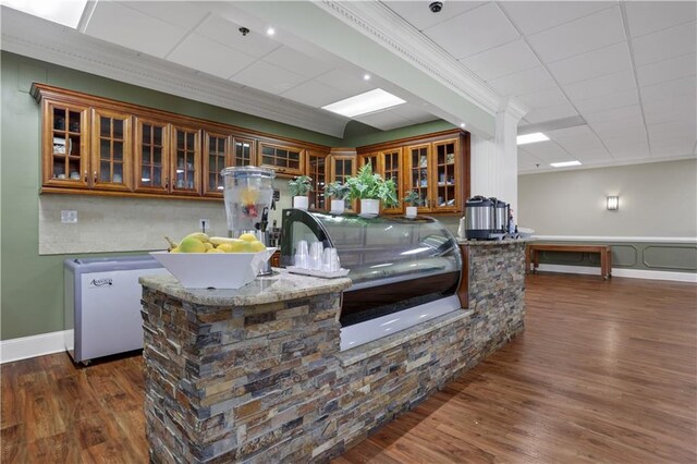 kitchen featuring crown molding, refrigerator, and dark wood-type flooring