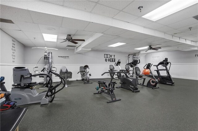 workout area with ceiling fan and a paneled ceiling