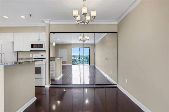 kitchen with a notable chandelier, stone counters, range, and dark hardwood / wood-style floors