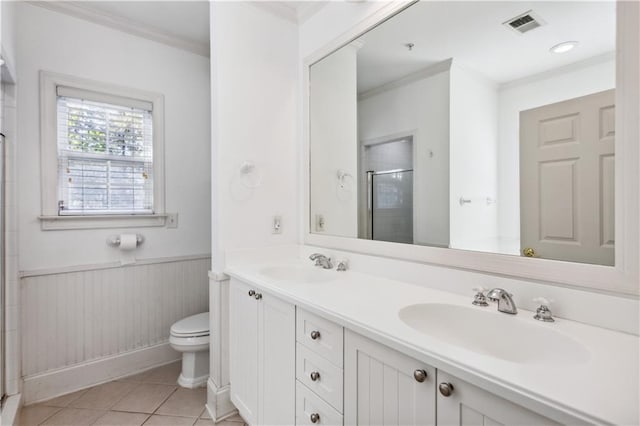 bathroom with a shower with door, toilet, tile patterned flooring, crown molding, and vanity