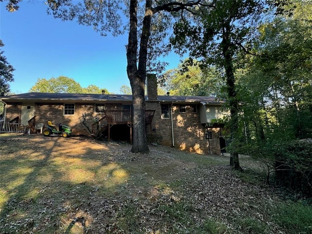 back of house with a deck