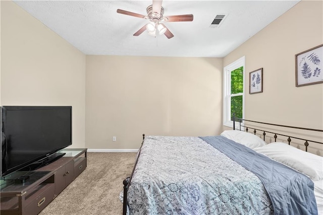 carpeted bedroom with baseboards and a ceiling fan
