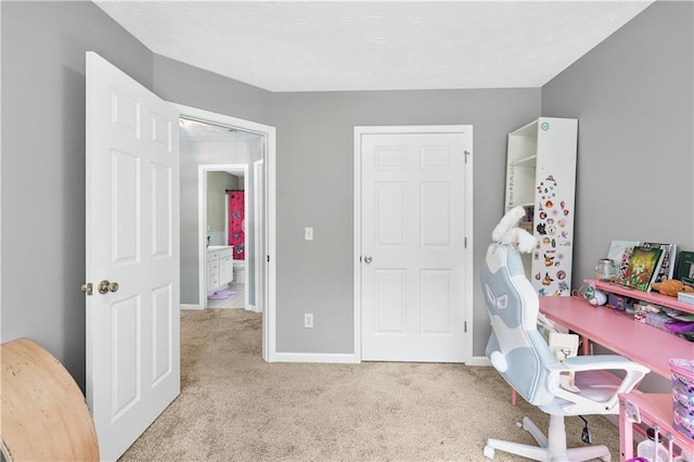 office featuring light carpet and baseboards