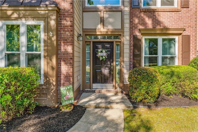 property entrance with brick siding