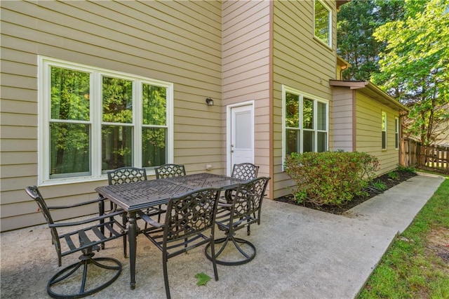 view of patio featuring fence and outdoor dining space