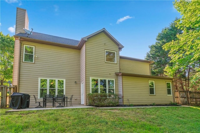 back of property featuring a patio and a chimney