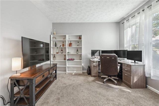 home office featuring carpet, a textured ceiling, and baseboards