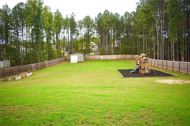 view of yard with a playground and a shed