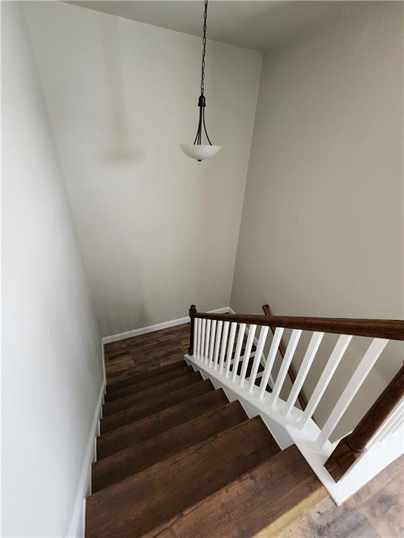 stairs featuring wood-type flooring