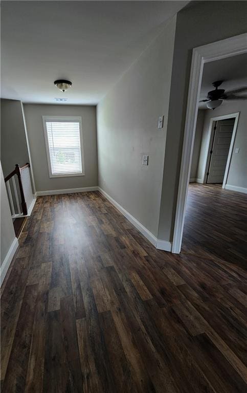 hallway with dark hardwood / wood-style flooring