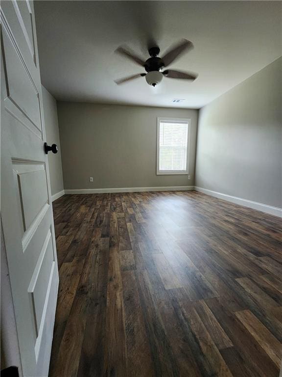 unfurnished room featuring dark hardwood / wood-style flooring and ceiling fan