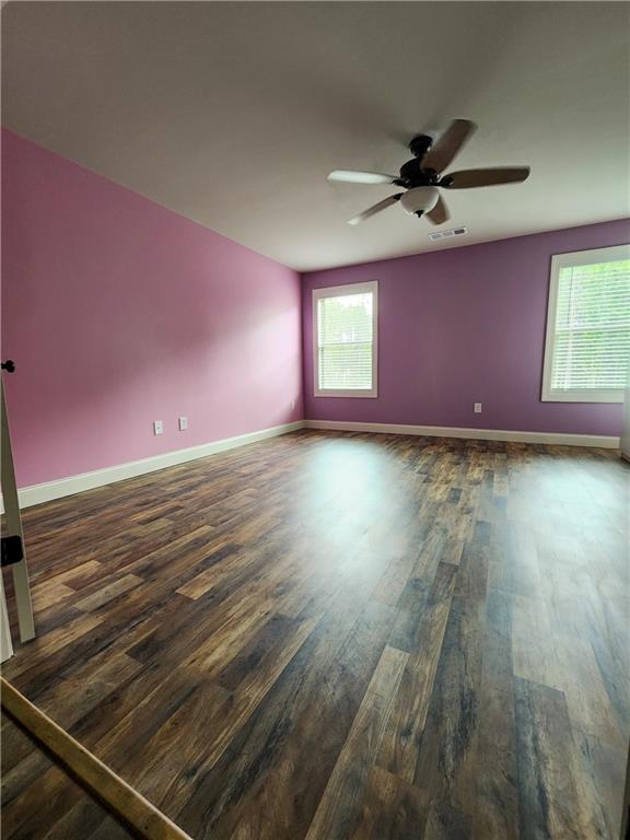 unfurnished room featuring ceiling fan and dark hardwood / wood-style floors