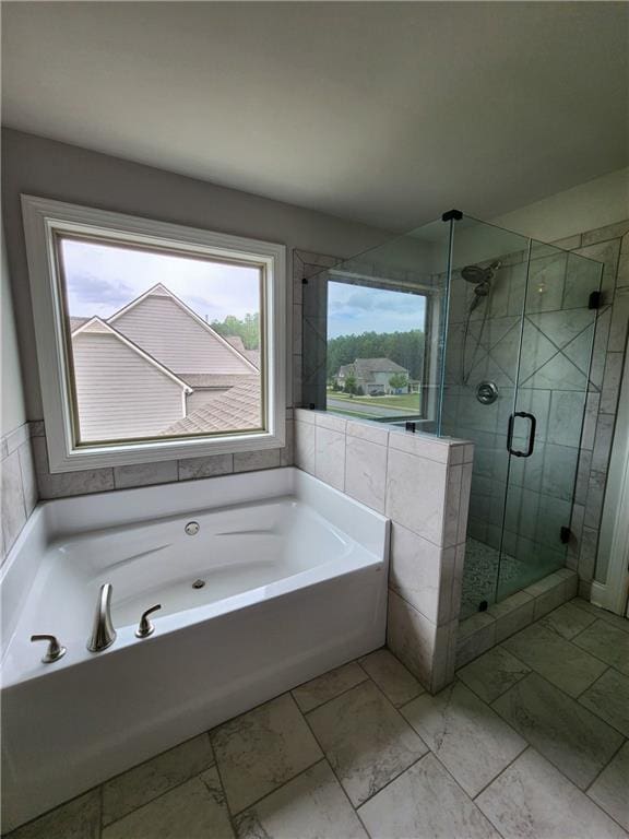 bathroom with separate shower and tub