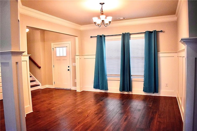 interior space with an inviting chandelier, crown molding, hardwood / wood-style floors, and a healthy amount of sunlight