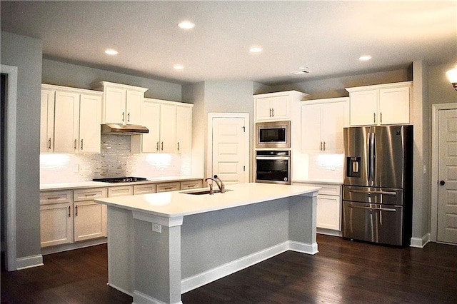 kitchen featuring a center island with sink, white cabinetry, sink, and stainless steel appliances