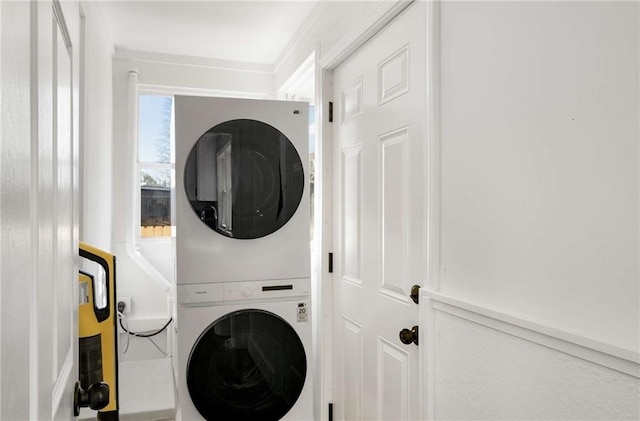 laundry area with stacked washer / drying machine