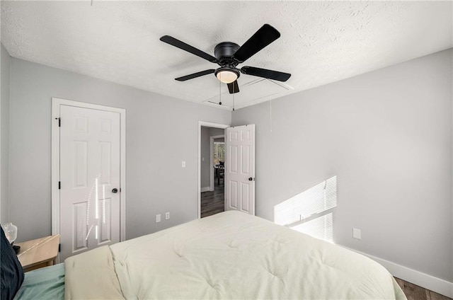 bedroom with dark wood-type flooring and ceiling fan