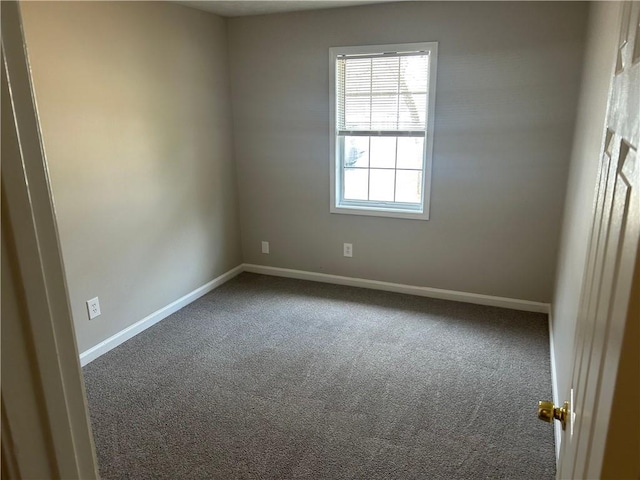 carpeted empty room with baseboards