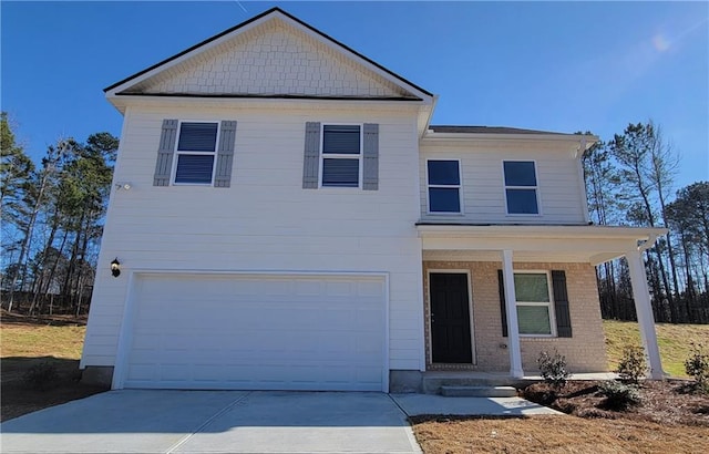 view of front of property featuring a garage and covered porch