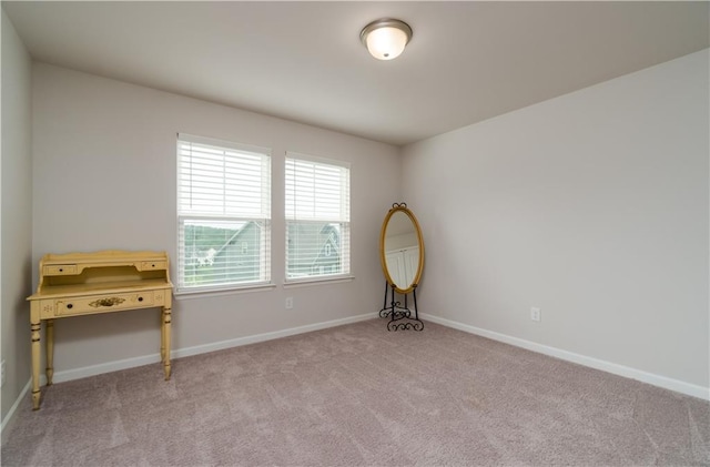 empty room with carpet and baseboards