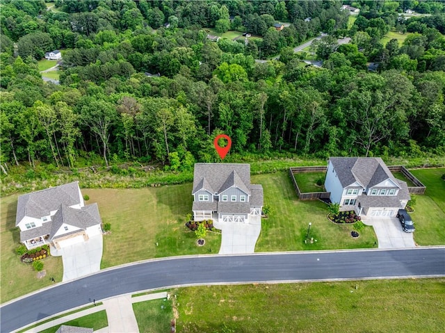 view of subject property featuring a heavily wooded area