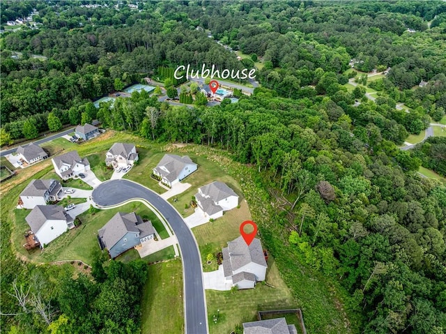 aerial overview of property's location featuring a heavily wooded area and nearby suburban area