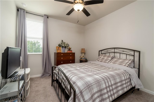 bedroom featuring light carpet, baseboards, and a ceiling fan