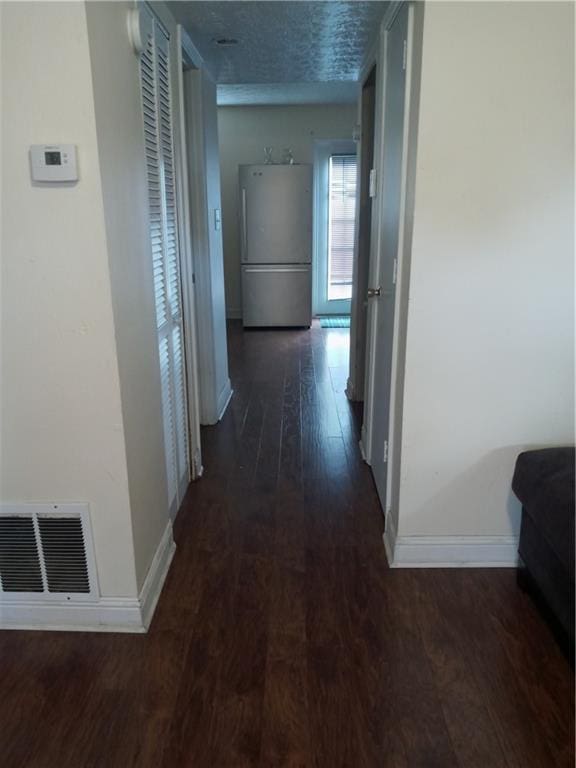 corridor featuring dark hardwood / wood-style floors