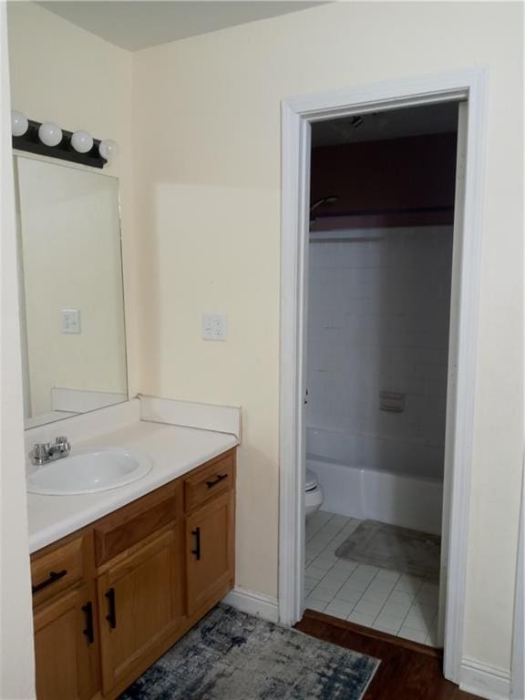 full bathroom featuring tile floors, shower / washtub combination, toilet, and vanity