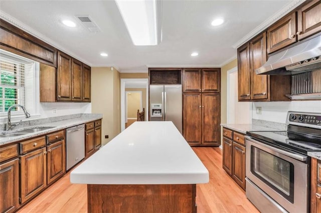 280 W Knight Rd W, Mcdonough, GA 30252 - kitchen with appliances with stainless steel finishes, under cabinet range hood, ornamental molding, light wood-style flooring, and a kitchen island