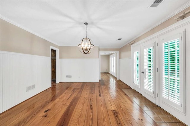 280 W Knight Rd W, Mcdonough, GA 30252 - unfurnished dining area featuring a chandelier, hardwood / wood-style flooring, a wainscoted wall, and ornamental molding