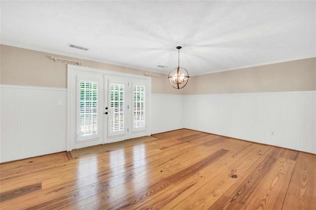 280 W Knight Rd W, Mcdonough, GA 30252 - empty room with a chandelier, hardwood / wood-style floors, a wainscoted wall, and ornamental molding