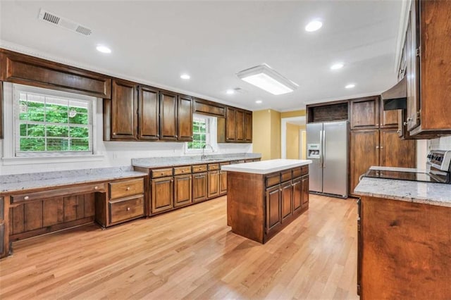 280 W Knight Rd W, Mcdonough, GA 30252 - kitchen with stainless steel refrigerator with ice dispenser, range, light wood-style flooring, a kitchen island, and recessed lighting