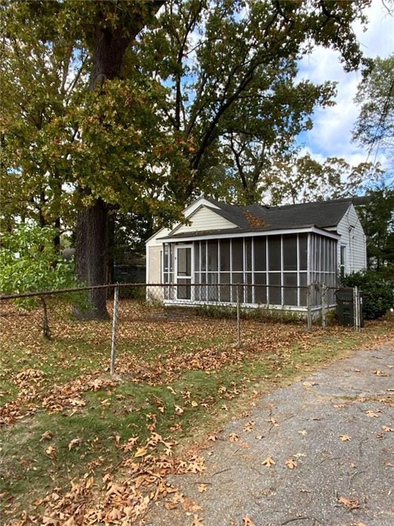 view of property exterior with a sunroom