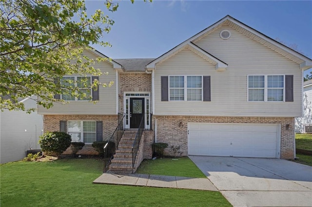 2551 Tolliver Dr, Ellenwood, GA 30294 - bi-level home with brick siding, a garage, concrete driveway, and a front lawn