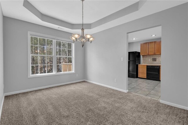 2551 Tolliver Dr, Ellenwood, GA 30294 - unfurnished dining area featuring baseboards, visible vents, an inviting chandelier, a raised ceiling, and light colored carpet