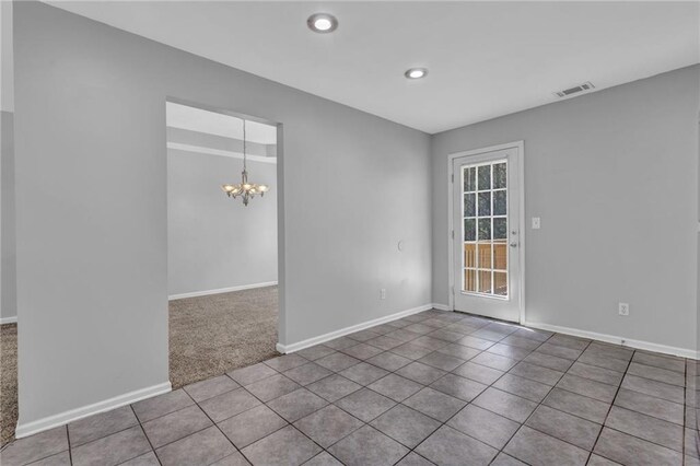 2551 Tolliver Dr, Ellenwood, GA 30294 - unfurnished room with an inviting chandelier, baseboards, visible vents, and tile patterned floors