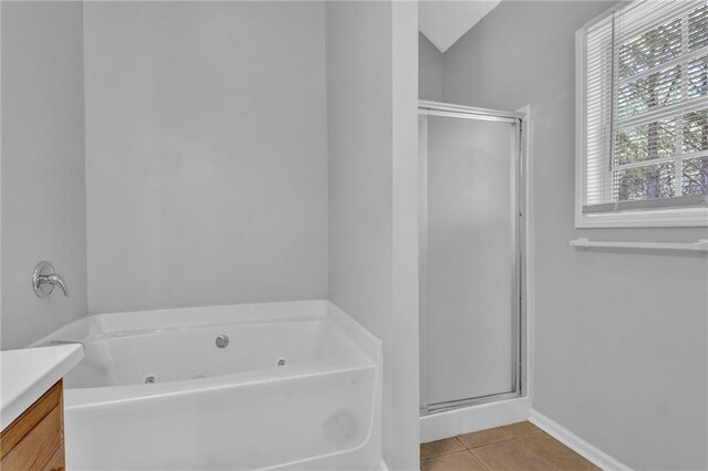 2551 Tolliver Dr, Ellenwood, GA 30294 - full bathroom with tile patterned flooring, vanity, a stall shower, and a tub with jets