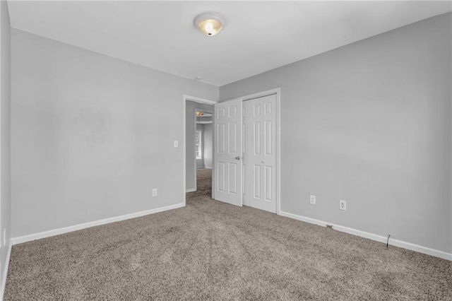2551 Tolliver Dr, Ellenwood, GA 30294 - unfurnished bedroom featuring carpet, baseboards, and a closet